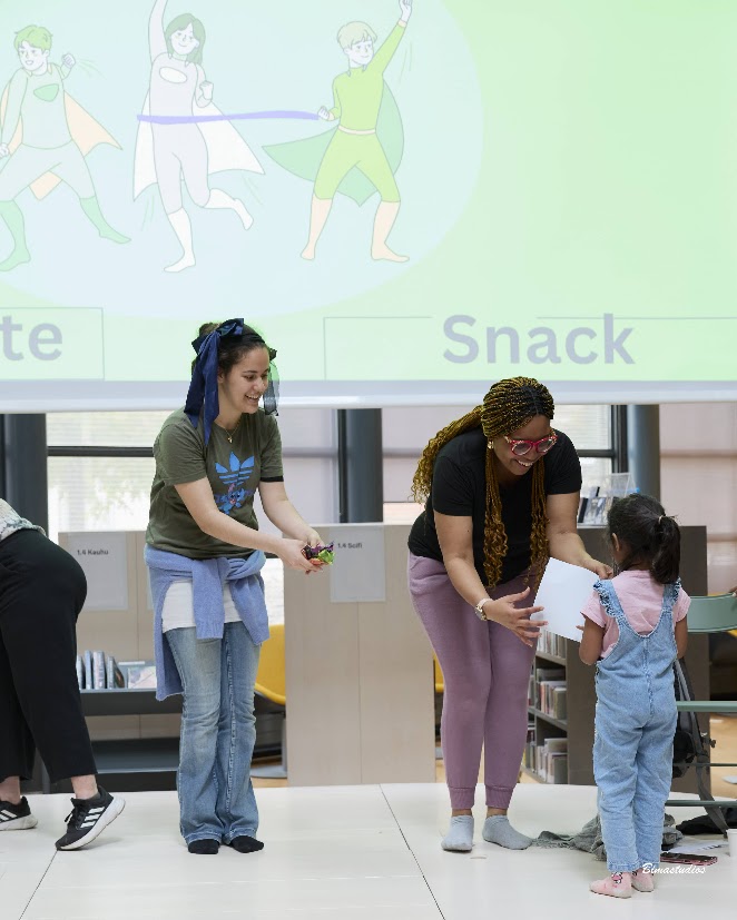 Facilitators handing out certificates to a child